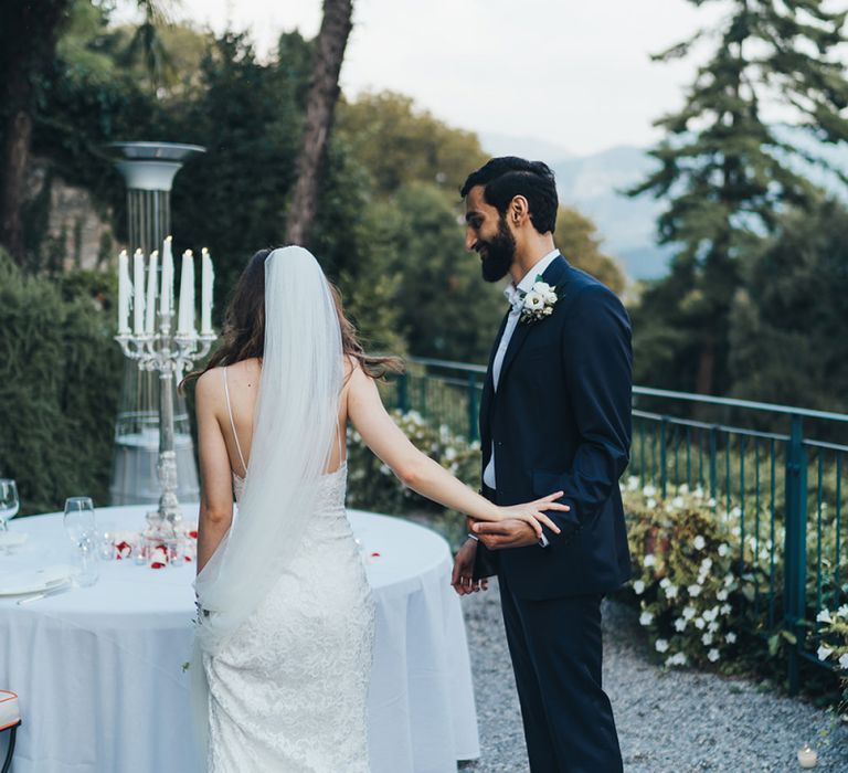 Bride in Grace Loves Lace Mia Wedding Dress and Groom in Taliare Navy Suit at their Intimate Wedding Reception