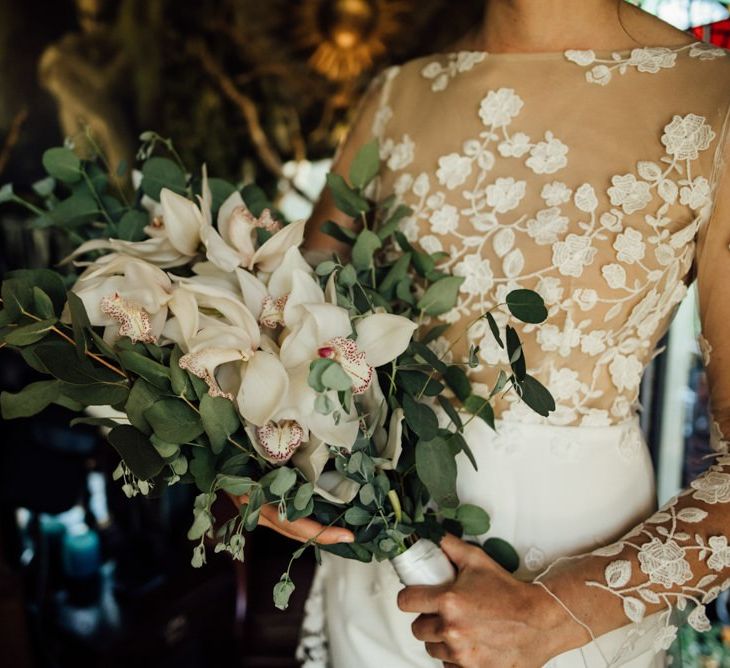 Bridal bouquet with white flowers at woodland wedding