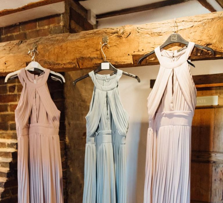 Pastel bridesmaid dresses at at same sex woodland wedding celebration in autumn