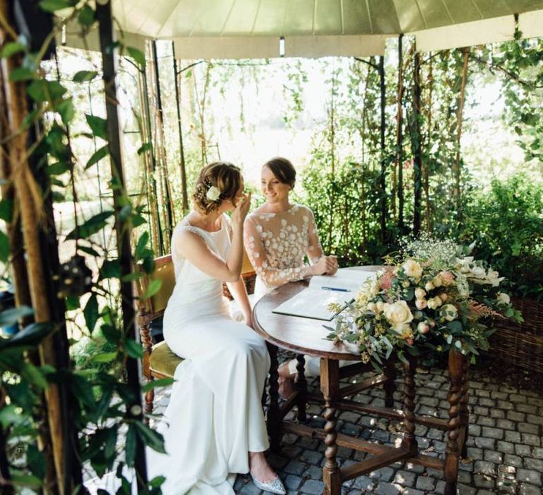 Brides tie the knot at outdoor wedding ceremony with gypsophila  decor