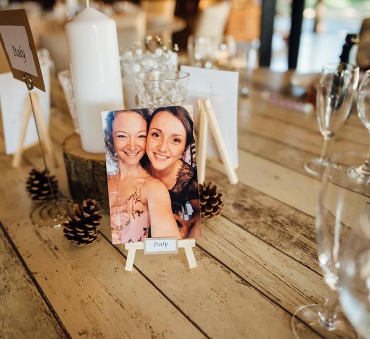 Personalised wedding table decorations with pinecones at woodland reception