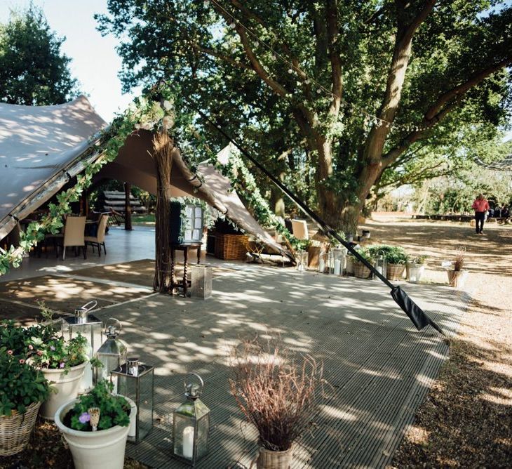 Entrance to marquee reception at woodland reception with gypsophila  decor