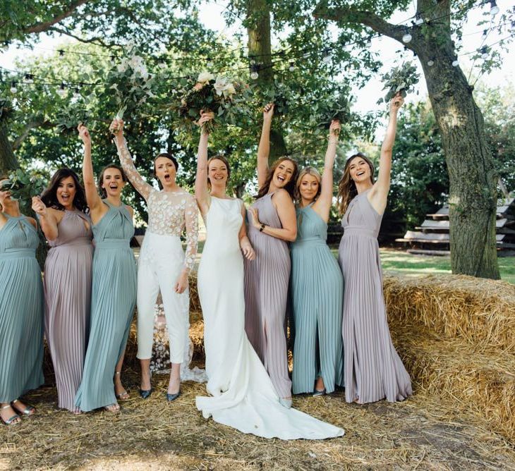 Autumn woodland celebration with bridesmaids in pastel halter neck dresses