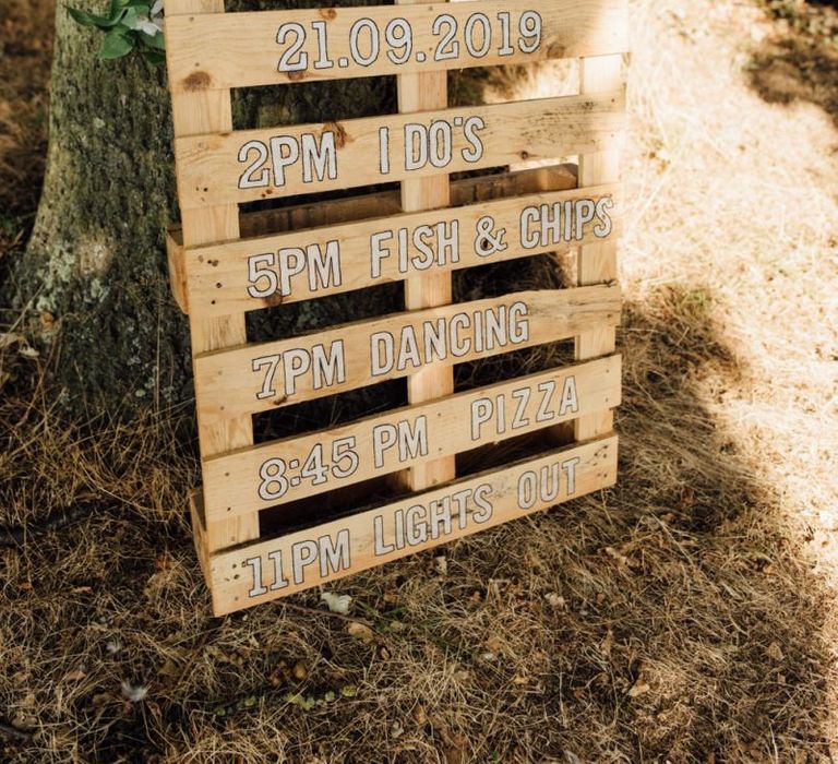 Wooden palettes order of the day at secluded woodland celebration in autumn