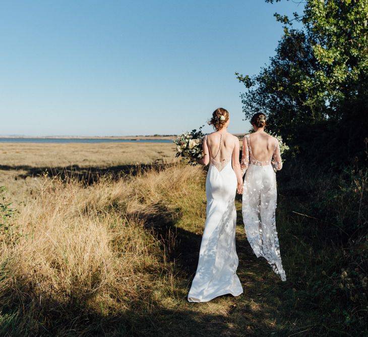 Two brides celebrating same sex reception in a  beautiful woodland setting