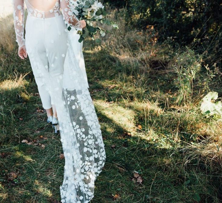 Overskirt appliqué detailing at secluded woodland event