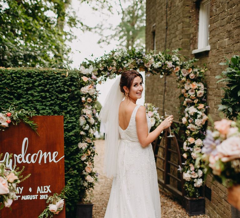 Floral Arch from Topiary Tree | Church Wedding Ceremony | Bride in Karen Willis Holmes | Groom in Custom Made Suit by Suit Supply | Summer Wedding at Family Home in Kent | Glass Marquee from Academy Marquees | Frances Sales Photography