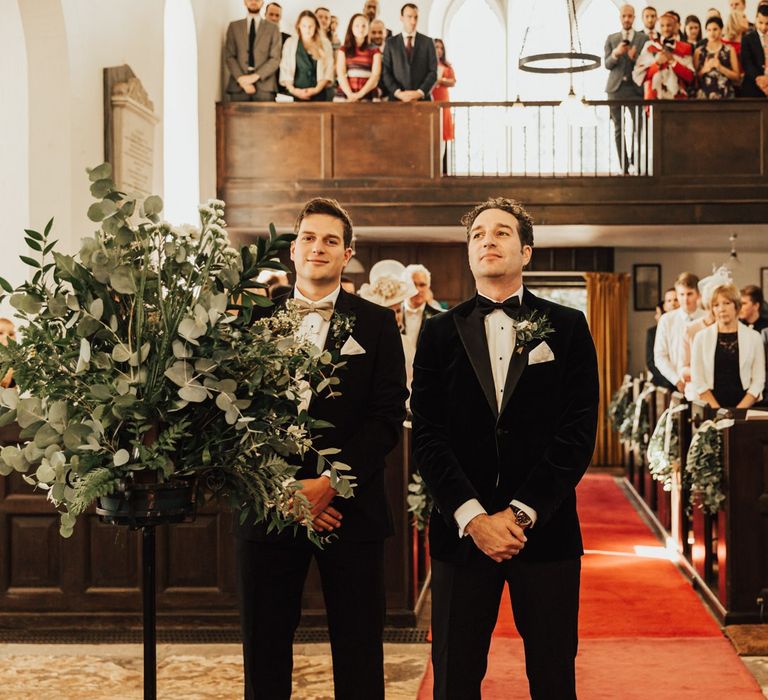 Groom in tux awaits bride's entrance