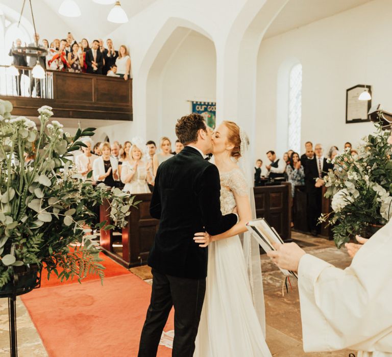 Bride and Groom kiss at the altar