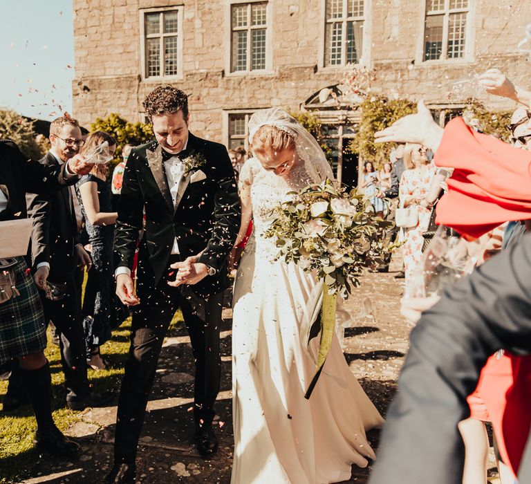 Bride and Groom confetti exit at Askham Hall wedding