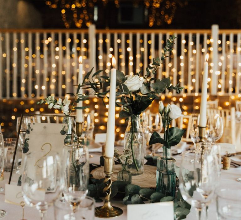 Beautiful wedding decor at Askham Hall wedding  with fairy light canopy candles and foliage