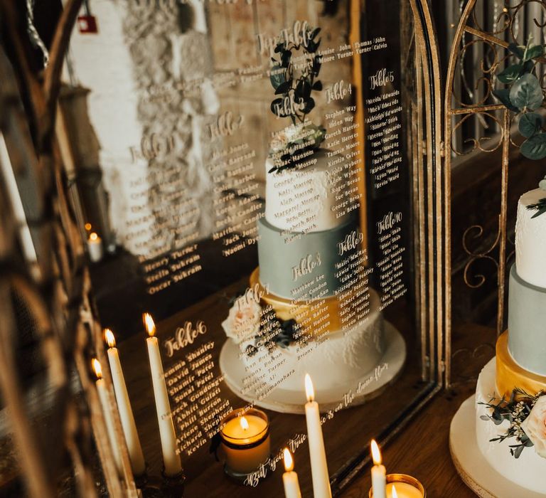 Mirrored seating char and green and gold wedding cake at Askham Hall wedding