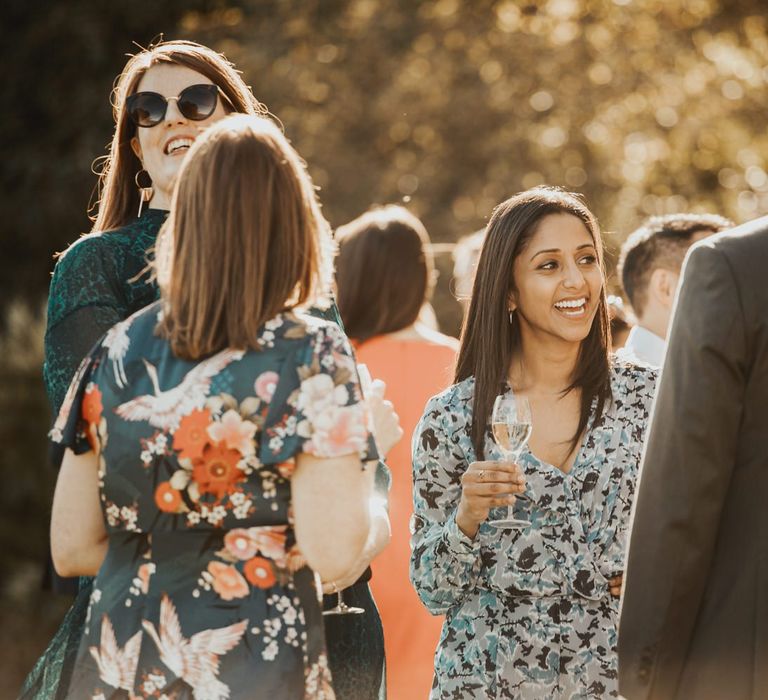 Guests enjoy drinks outside Askham Hall wedding venue