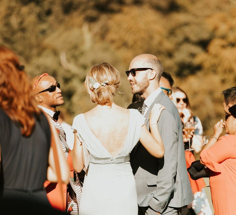 Guests enjoy drinks outside Askham Hall wedding venue