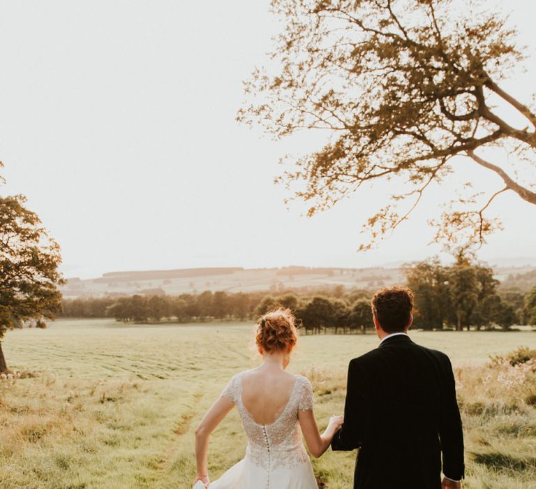 Ivory &amp; Co Bridal wedding dress with lace capped sleeves and bridal updo