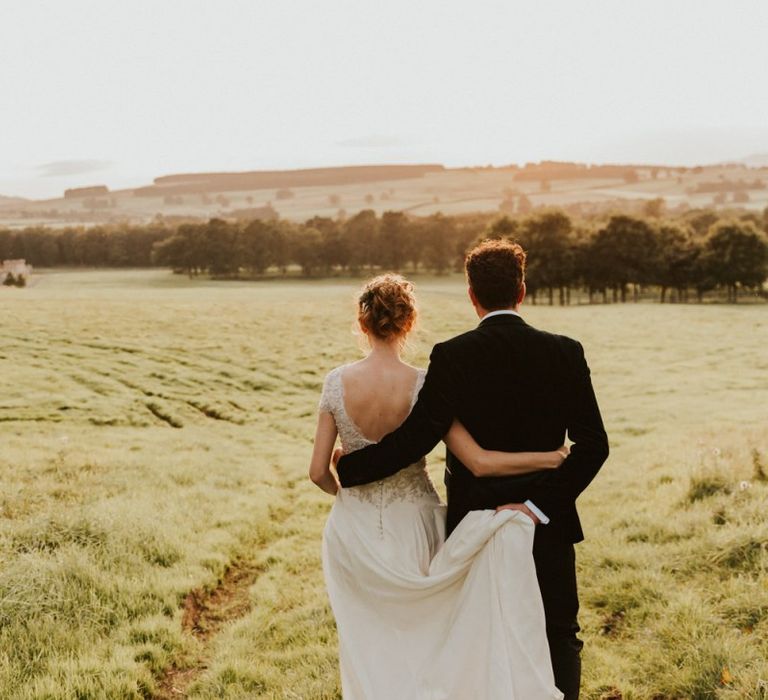 Bridal updo with low back wedding dress at Askham Hall wedding