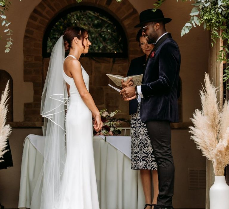 Bride and groom exchanging vows at The Ravenswood wedding ceremony