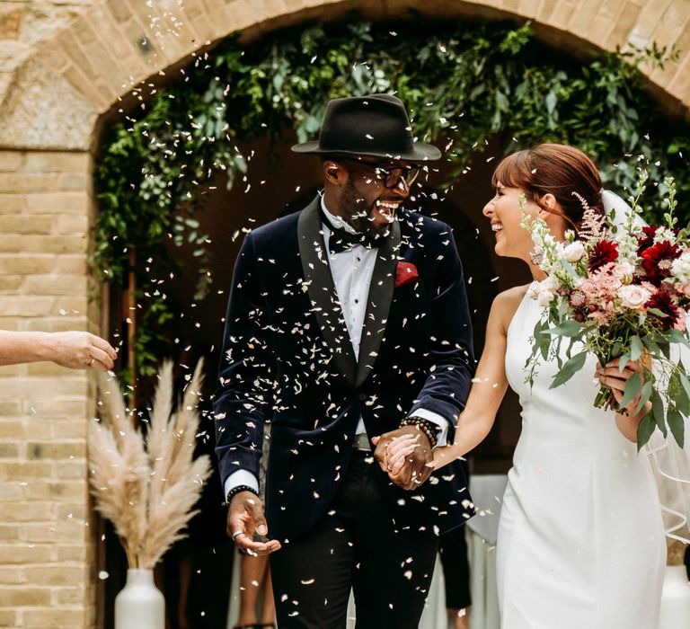 Bride and groom confetti moment at The Ravenswood