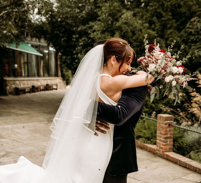 Groom picking up his bride with joy