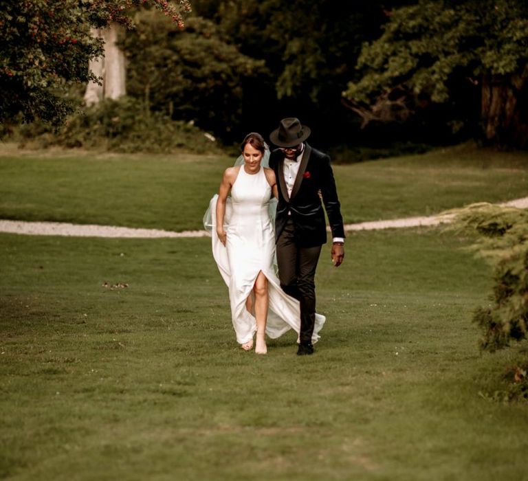 Stylish bride and groom walking arm in arm