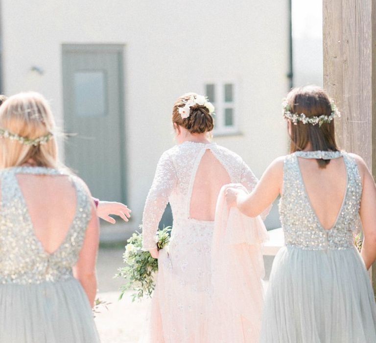 Bridesmaids in Sequin and Tulle Dresses Holding the Brides Train