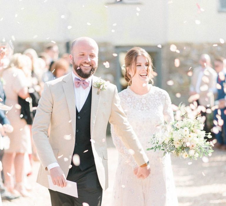 Confetti Moment with Bride in Needle &amp; Thread Ombre Wedding Dress and Groom in Beige Blazer and Pink Bow Tie