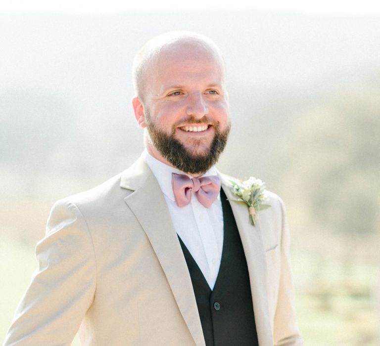 Groom in Black Suit with Beige Blazer and Pink Bow Tie