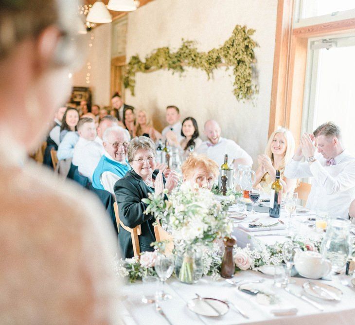 Wedding Guests Clapping at the Bride and Groom Enter The Wedding Reception