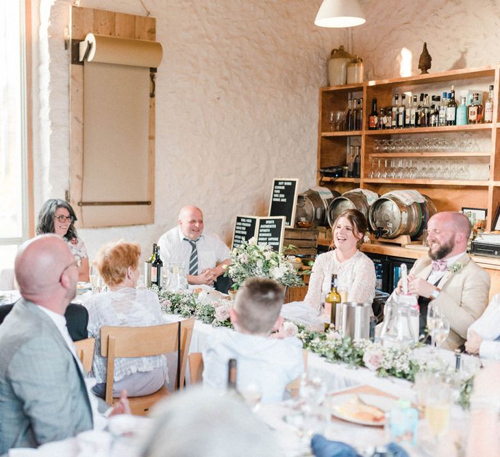 Bride and Groom Laughing During Wedding Reception Speeches