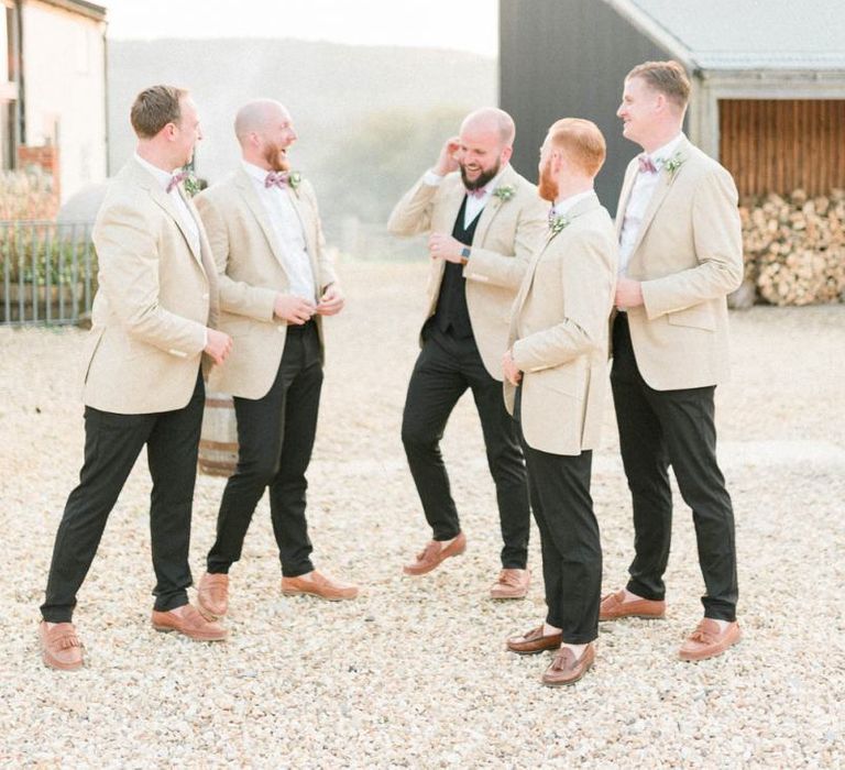 Groomsmen in Black Suits with Beige Jackets and Bow Ties