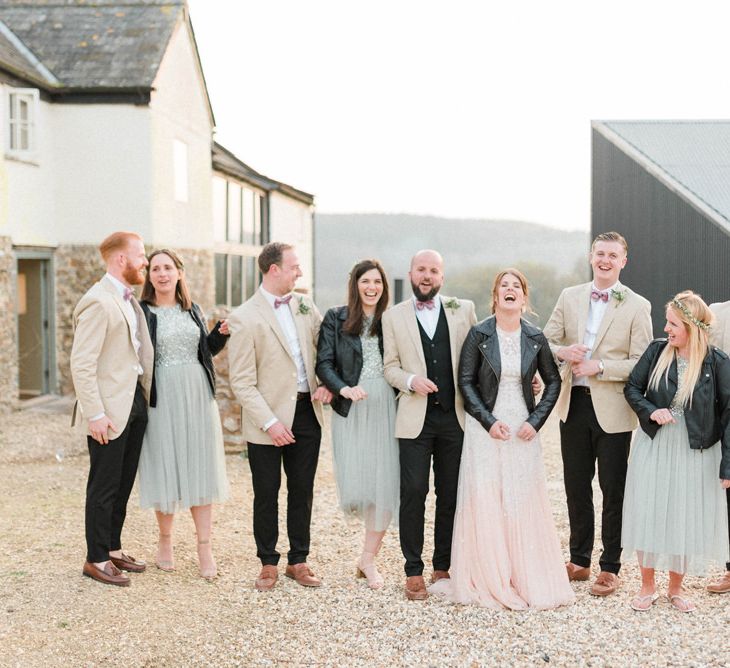 Wedding Party Portrait with Groomsmen in Beige Blazers and Bridesmaids in Leather Jackets