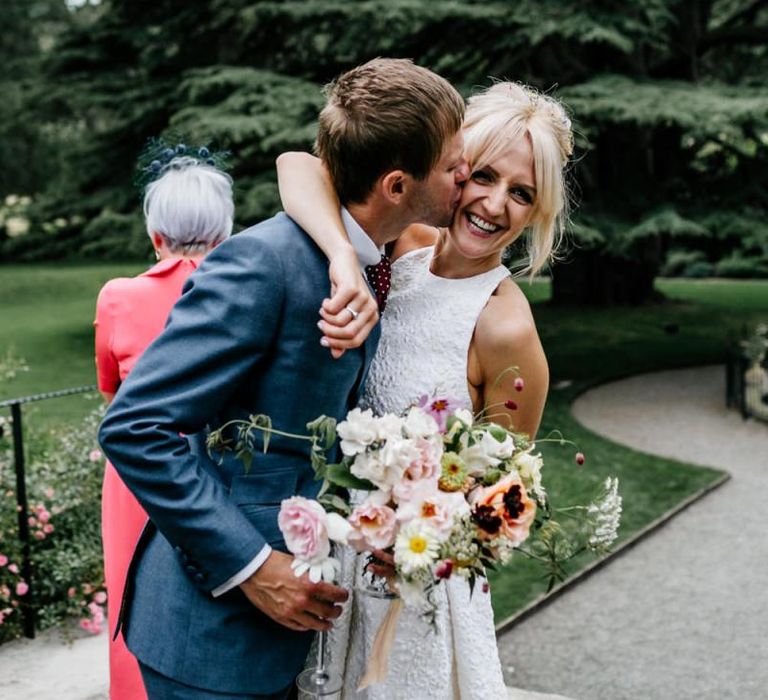 Bride and Groom Embrace After Ceremony