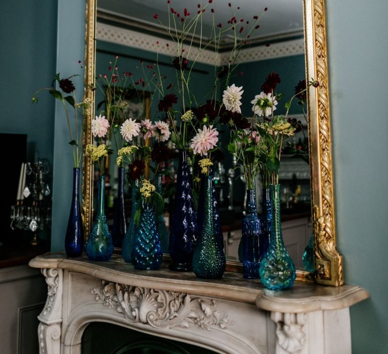 Mirror with Flower stems in vintage jars