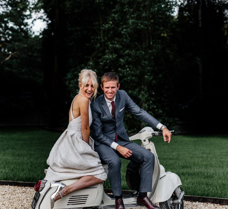 Bride and Groom Pose on Wedding Transport Choice Vintage Vesper