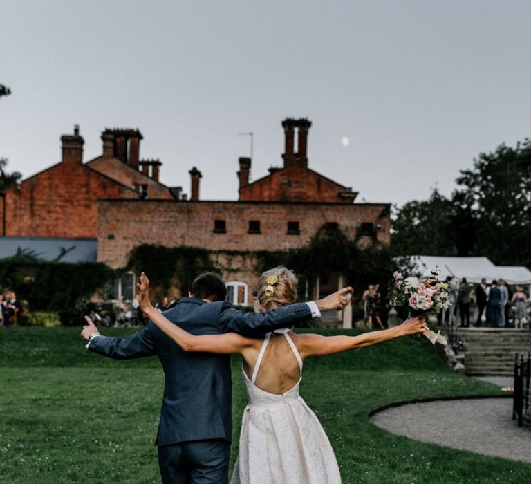 Open Back Charlie Brear Wedding Dress and Grey Suit