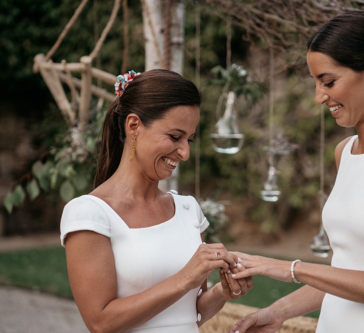 Brides exchange rings at destination wedding