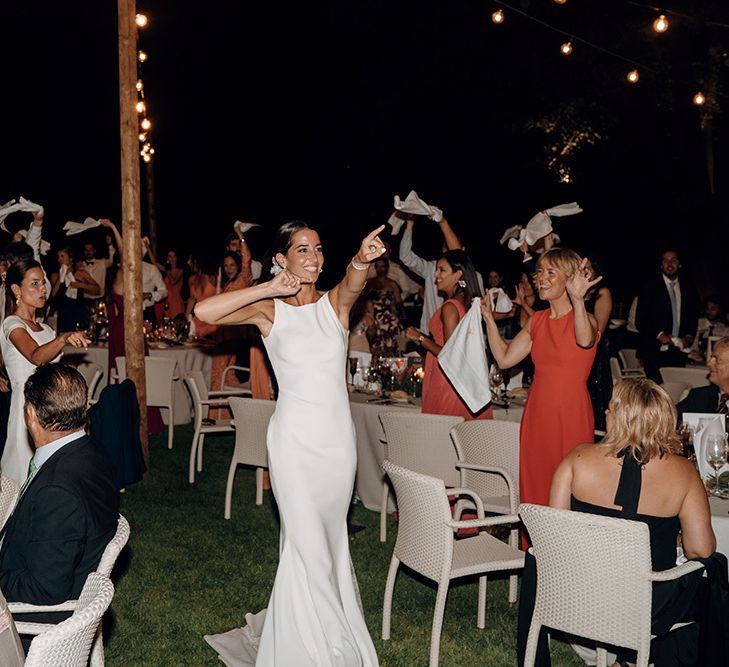 Brides enter reception in fitted wedding dresses