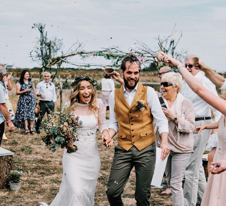 Confetti exit for bride and groom at rustic wedding