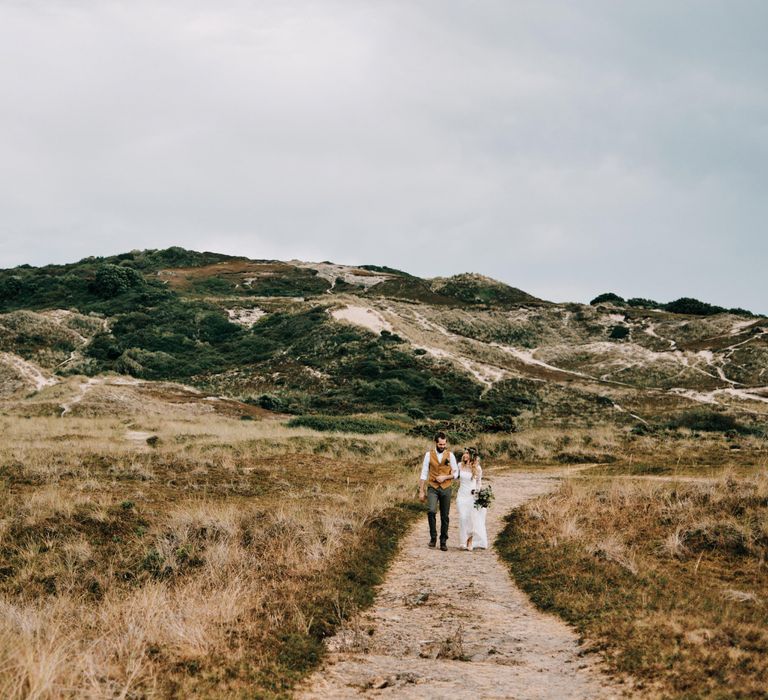 Coastal outdoor wedding with rustic decor and globe guest book