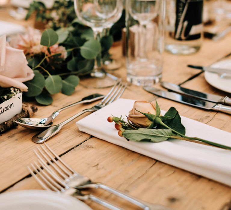 Wedding table decor with soft florals and foliage table runner