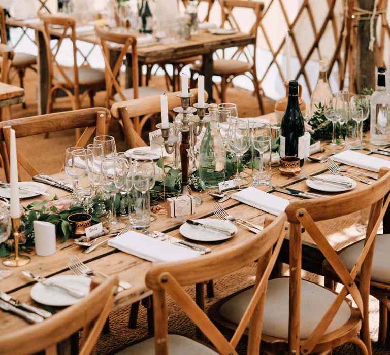 Wedding table decor in yurt with rustic globe guest book