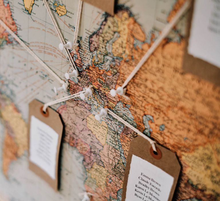 Map seating chart at wedding with globe guest book