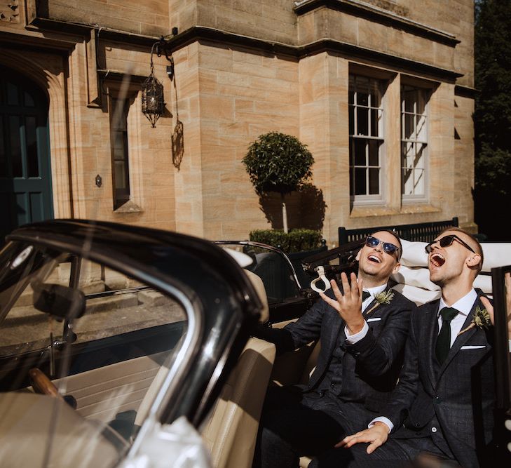 Two Groom Sitting in Their Wedding Car