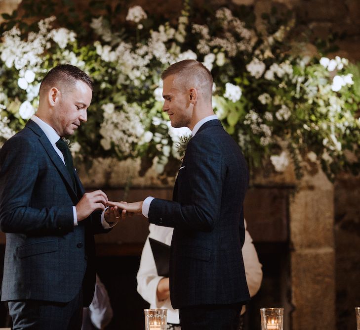 Two Grooms Exchanging Rings  at Their Same-sex Wedding