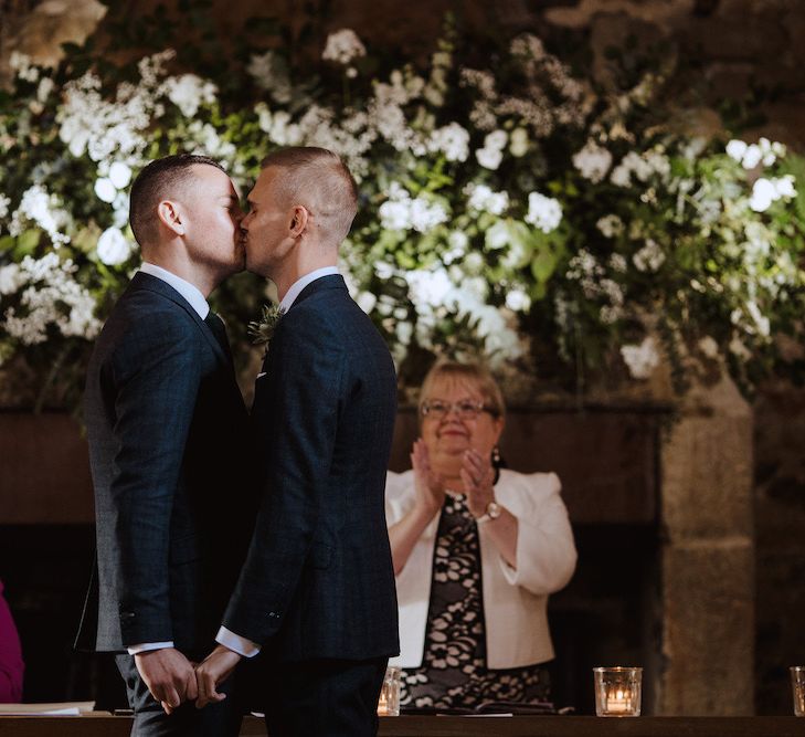 Two Grooms Kissing  at Their Same-sex Wedding