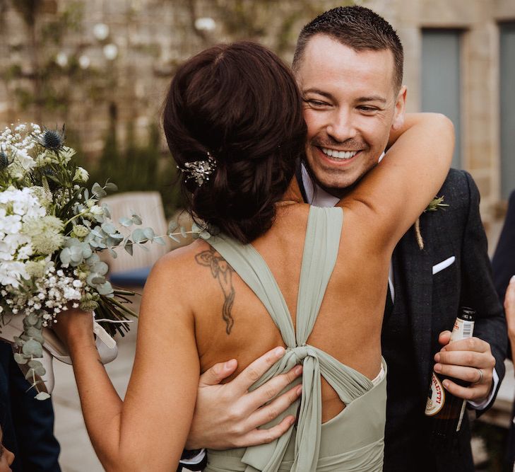 Bridesmaid in Crossover Back Dress Embracing the Newly Weds