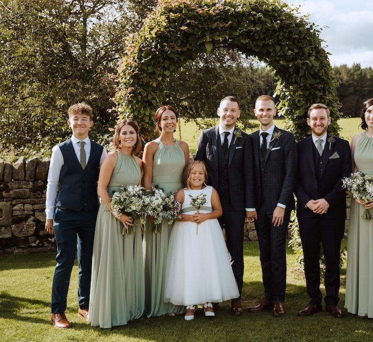 Wedding Party Portrait with Bridesmaids in Green Dresses and Grooms in Tailored Suits