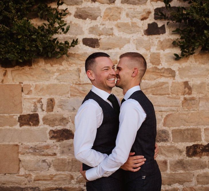 Two Grooms Embracing at their Gay Wedding