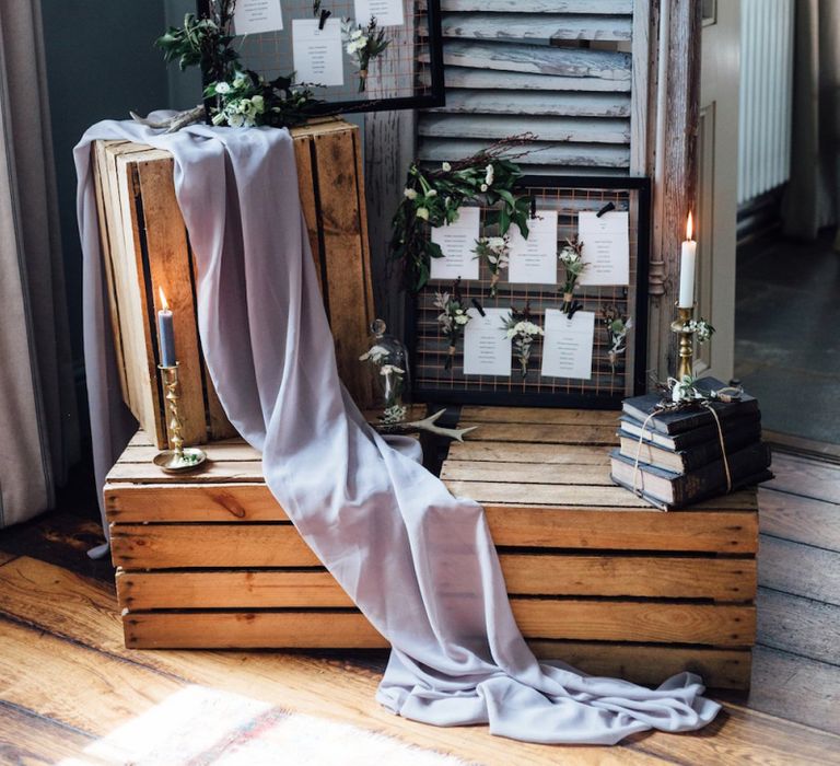 Table Plan on Wooden Crates with Vintage Books and Candle Sticks