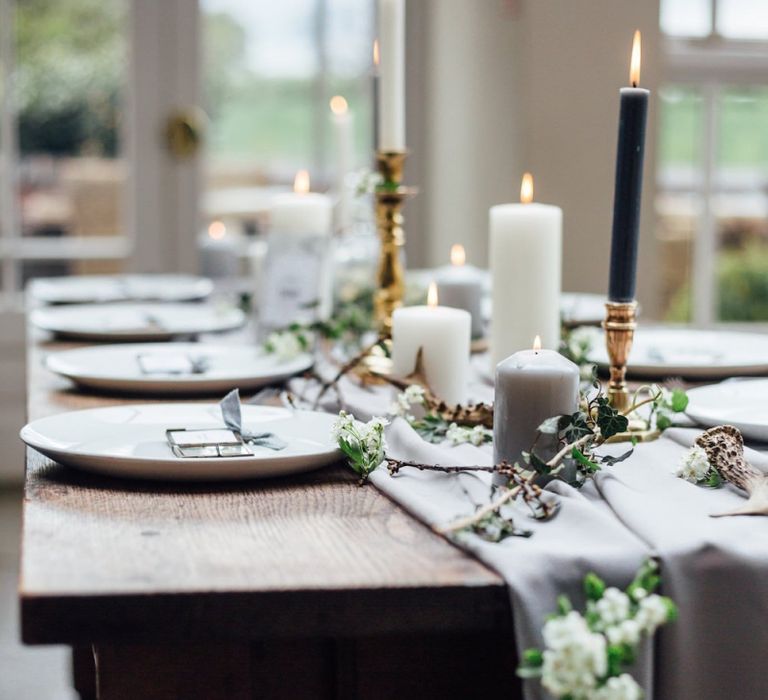 Wooden Table with Grey Table Cloth, White Tableware and Taper Candles